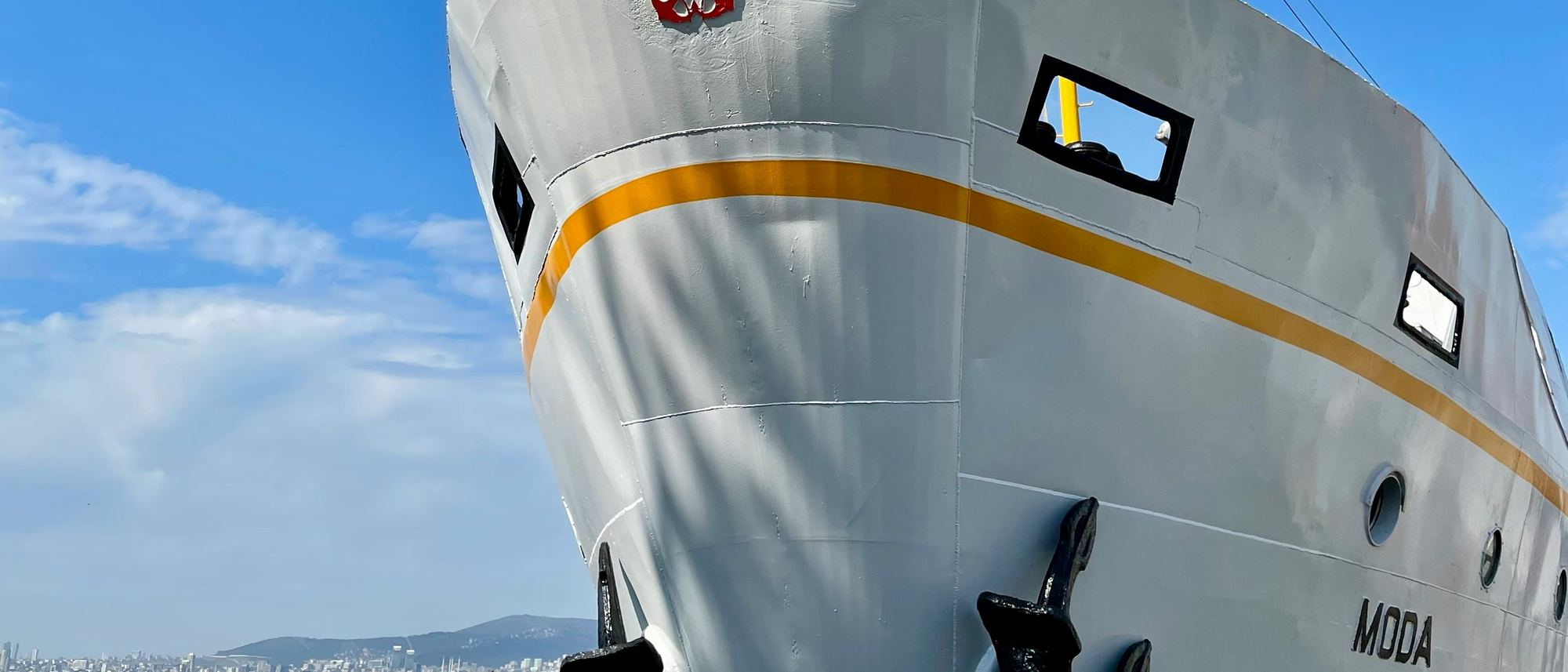 The bow of a ship in Istanbul, with the city on the horizon