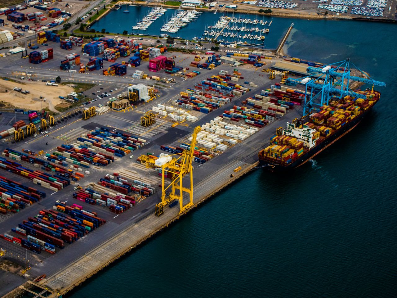 A container terminal from the air, with a ship alongside